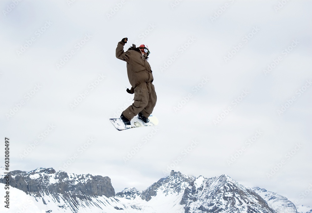 a snowboarder jumping high in the air a snowboarder jumping high in the air