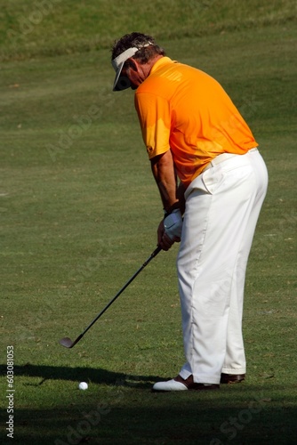 A golfer playing golf in the field.