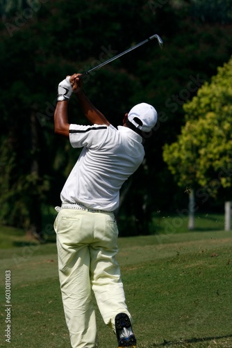 A golfer playing golf in the field.