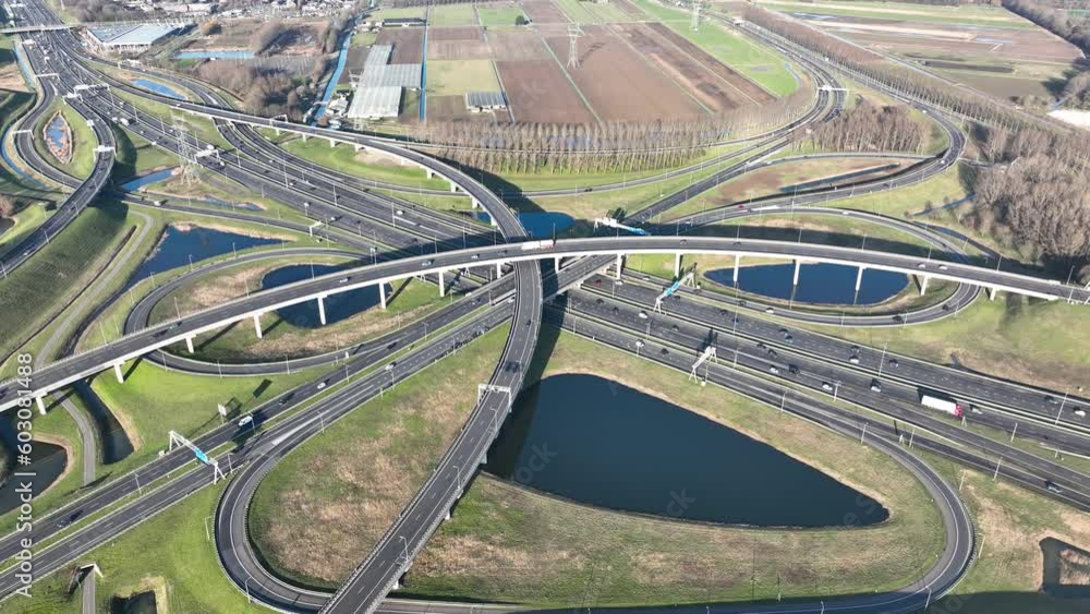 Top down aerial view from drone on a modern traffic intersection of multiple lane highway road. Top down aerial view from drone on a modern traffic intersection of multiple lane highway road.