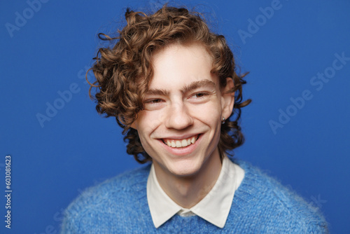 Toothy grin. Headshot. Androgyne face. Blue Background