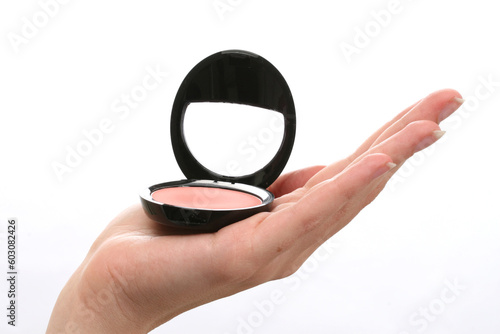 Blusher in a pot balanced on a hand