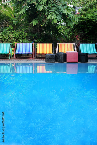 Row of deck chairs by a swimming pool
