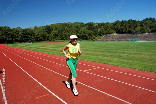 Active senior woman jogging in a stadium © Designpics
