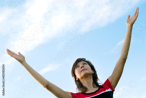beautiful young woman on the sky background, with copy-space