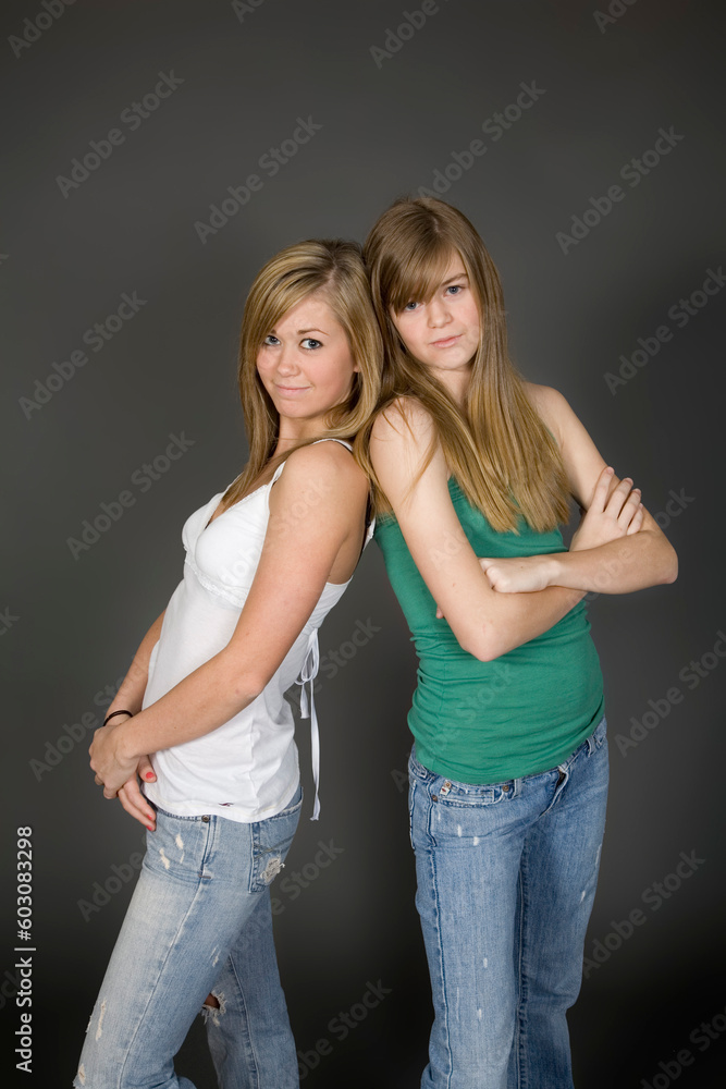 Teenage girls posing on gray background with some attitude Teenage girls posing on gray background with some attitude