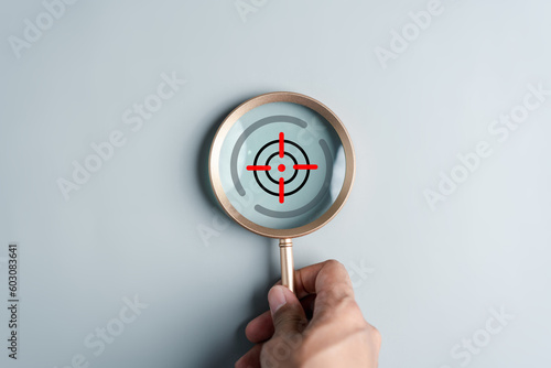 Magnifier glass focus to aiming target icon for planning development leadership and customer target group concept.