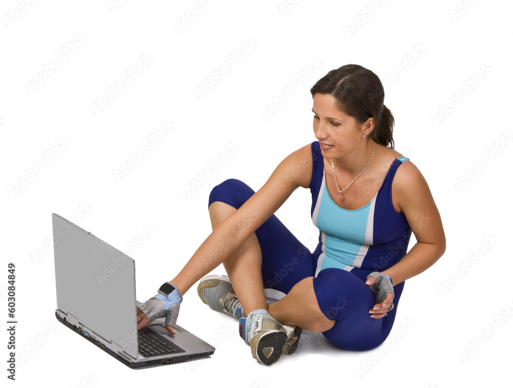 Woman in training equipment searching for something on a laptop. Woman in training equipment searching for something on a laptop.