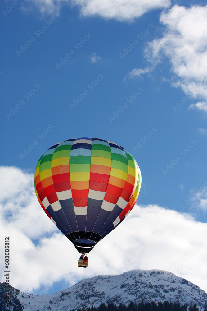 Fototapeta premium Colorful hot air balloon flying against a blue sky background