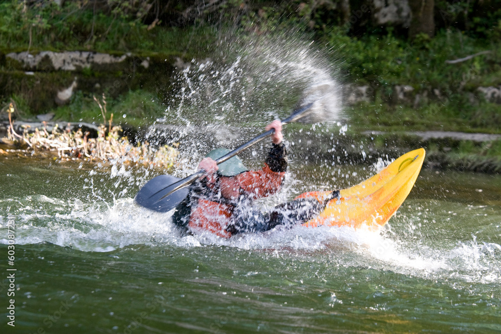 Fototapeta premium expert white water kayak paddler performing tricks