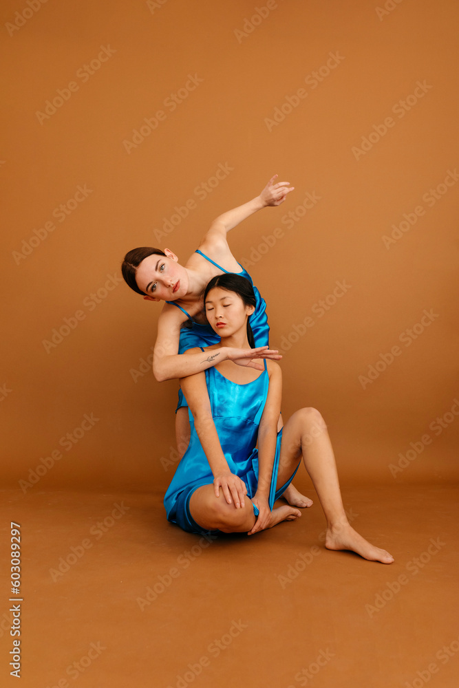 Young diverse women in dance pose in studio Young diverse women in dance pose in studio