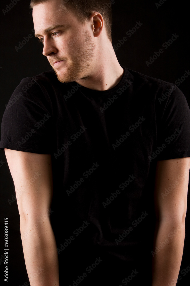 young man portrait on black background