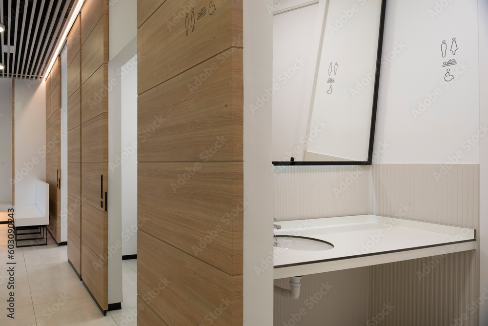 Modern clinic bathroom space with gender signs Stock Photo | Adobe Stock