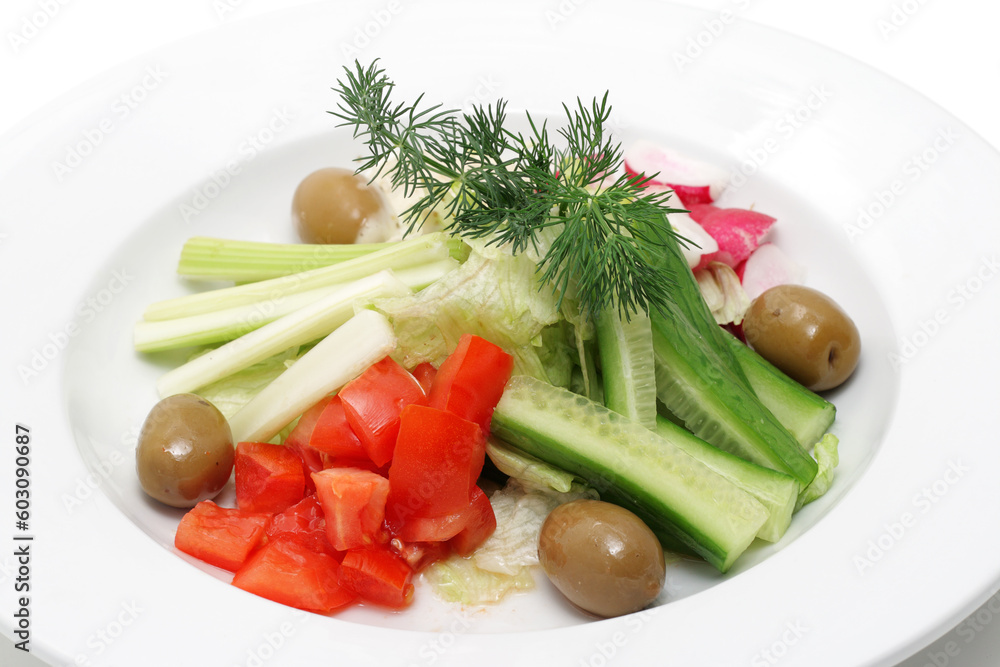 Vegetables on a plate isolated over white.
