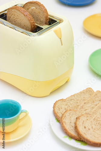 A table setting with breakfast food and toaster
