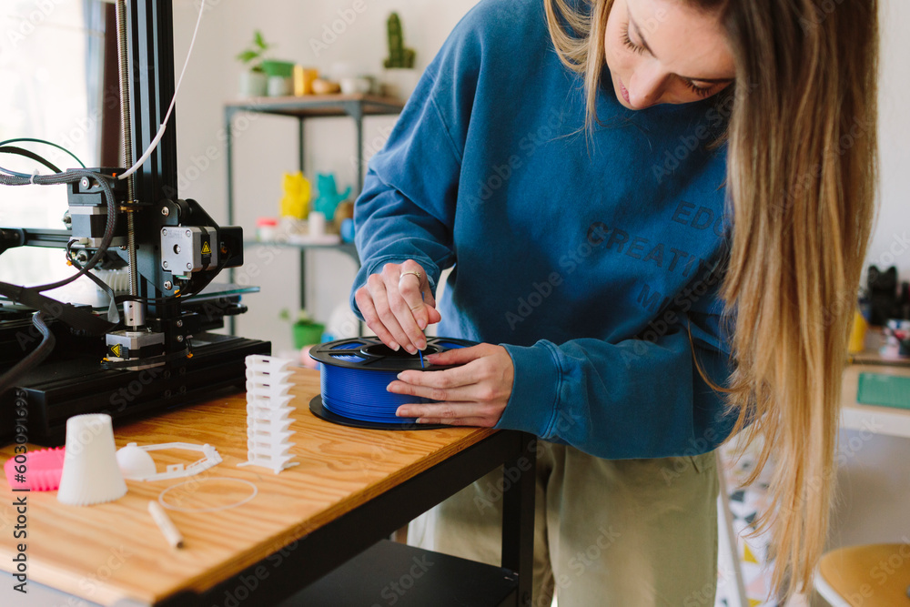 Woman working with a 3D printer Woman working with a 3D printer
