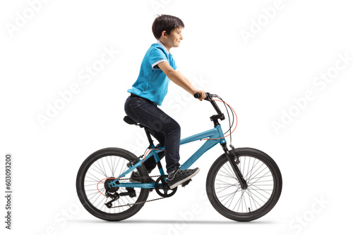 Full length profile shot of a boy riding a blue bicycle