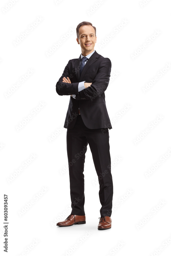 Full length portrait of a businessman posing with folded arms and smiling Full length portrait of a businessman posing with folded arms and smiling