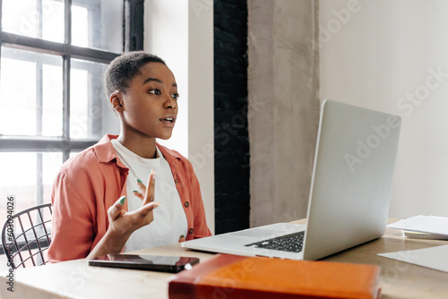 Black woman leading webinar on laptop photo