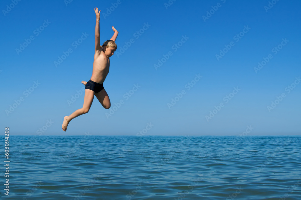 Yang boy jumping into the sea