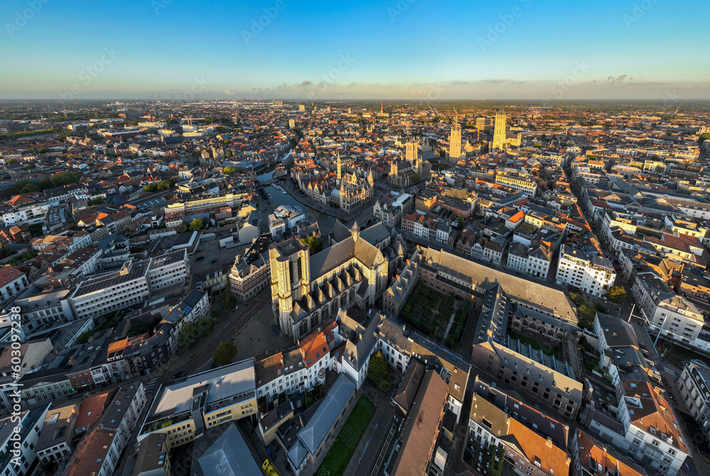 Obraz premium Ghent Belgium Aerial Flying over downtown area with church cityscape views at sunset time - October 2022