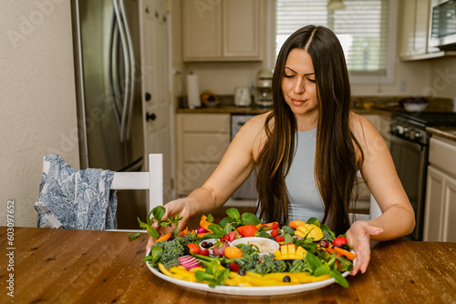 Latina woman prepares vegetarian board