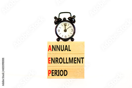 AEP symbol. Concept words AEP Annual enrollment period on beautiful wooden block. Black alarm clock. Beautiful white table white background. Medical AEP Annual enrollment period concept. Copy space.