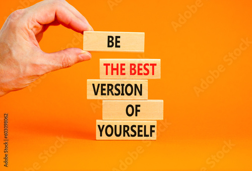 Motivational inspirational symbol. Concept words Be the best version of yourself on wooden block. Beautiful orange background Businessman hand. Business motivational inspirational concept. Copy space.