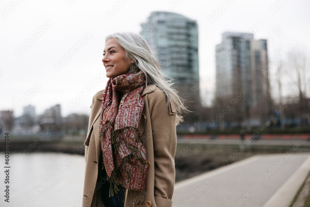 Stylish woman outside wearing jacket and scarf in winter. Stylish woman outside wearing jacket and scarf in winter.