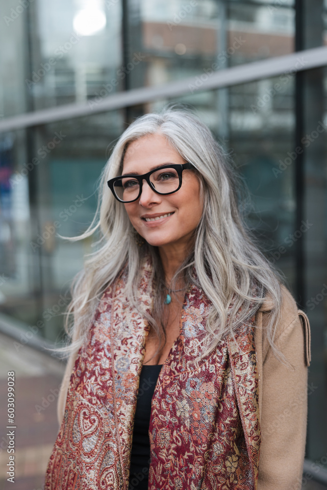 Stylish woman outside wearing jacket and scarf in winter. Stylish woman outside wearing jacket and scarf in winter.