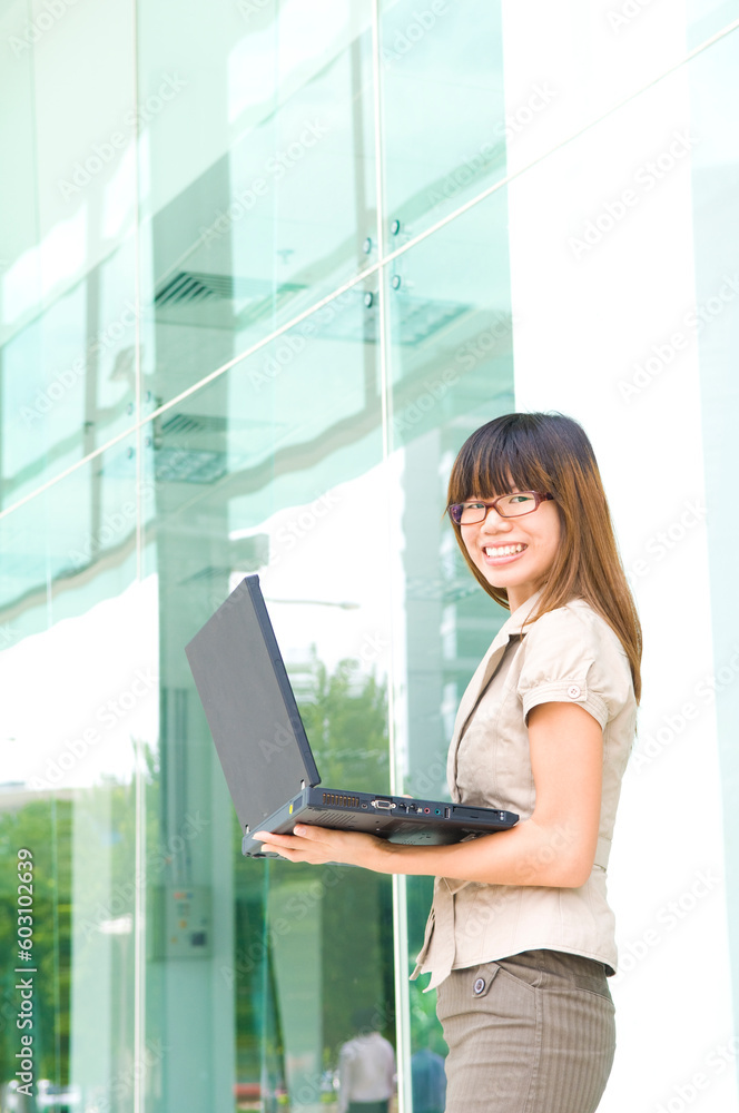 asian business women smiling with a laptop