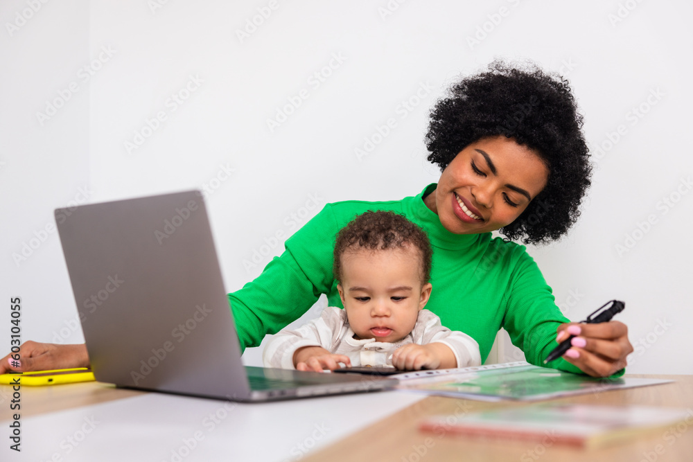 Black mother teleworking at home with her baby Black mother teleworking at home with her baby
