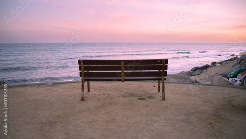 Empty bench watching the sunset photo