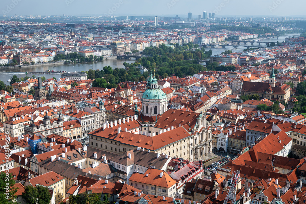 Aerial panoramic view of Prague, with St. Nicholas Church to be recognised against a cloudy sky.