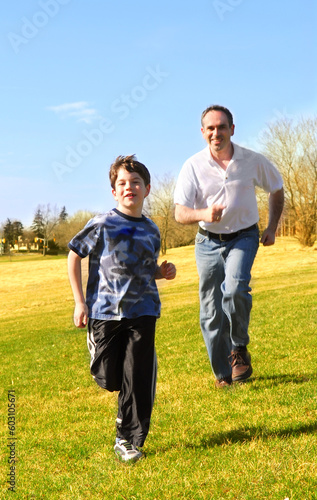 Portrait of father and son playing outdoors