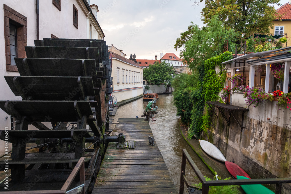 Wooden water mill with gremlin in Kampa Island on the banks of Vltava river in Prague, Czech Republic.