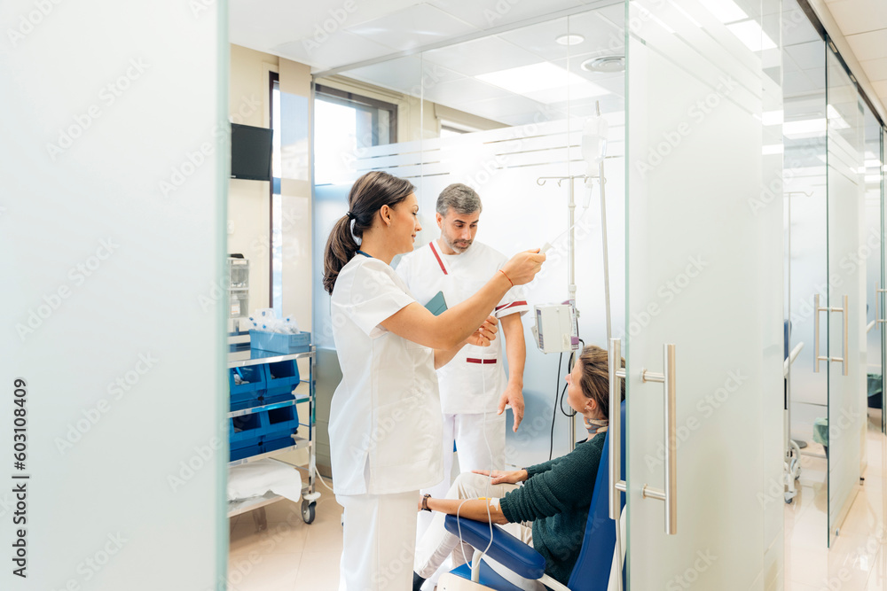 Doctor and nurse attending a patient in the hospital Doctor and nurse attending a patient in the hospital