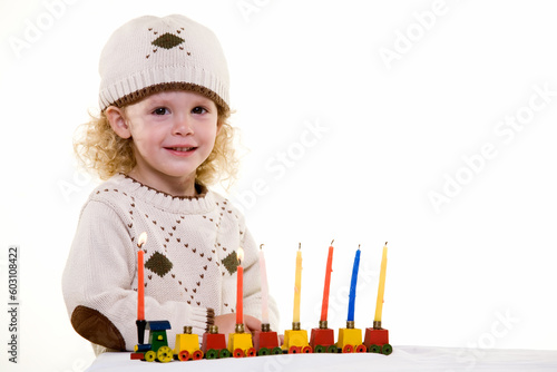 Fotografia Young blond hair three year old boy lighting the candles in the Jewish tradition