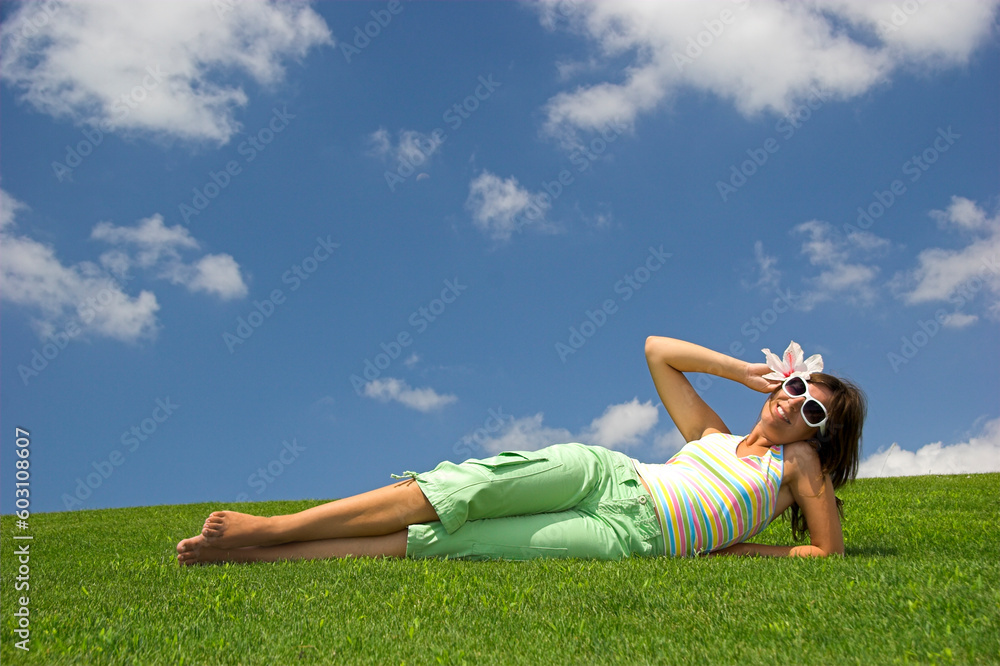Beautiful young woman on a green meadow with a flower Beautiful young woman on a green meadow with a flower