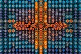 A composition of multiple vials filled with colorful vaccines, arranged in a symmetrical pattern, highlighting the efficiency and scale of production. Generative AI