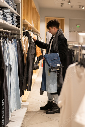 Wallpaper Mural Young adult shopping for clothes at store Torontodigital.ca