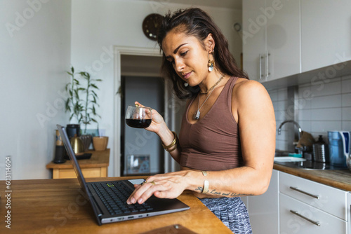 Focused young woman drinking coffee photo