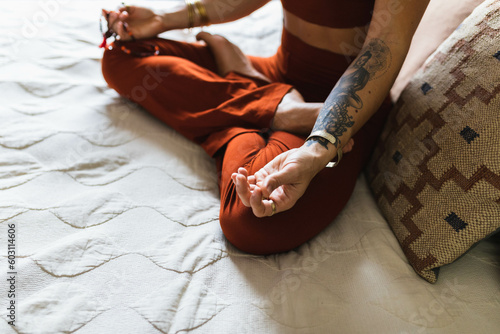 Woman meditating on bed photo