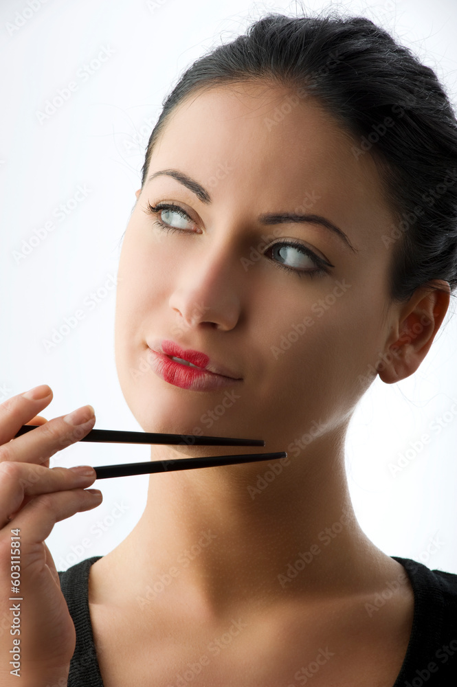 pretty woman with classic japanese make up on her lips and black chopstick pretty woman with classic japanese make up on her lips and black chopstick