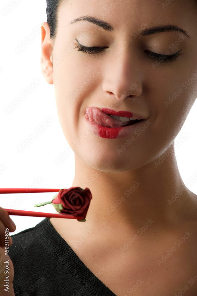 pretty woman with a rose between chopsteck making face pretty woman with a rose between chopsteck making face