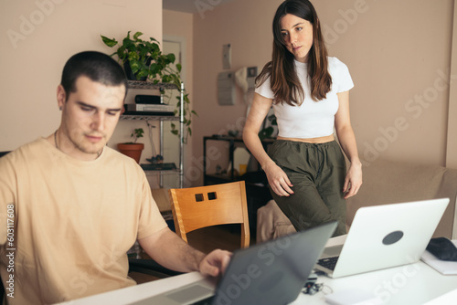 Home office: couple teleworking with laptop at home photo