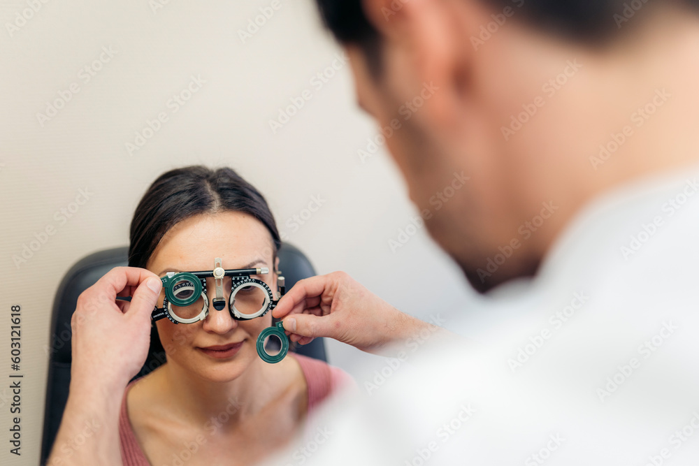 Patient at an eye check-up in phoropter Patient at an eye check-up in phoropter