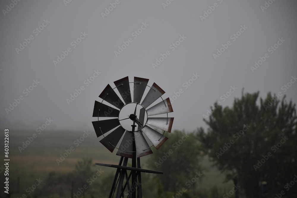 Windmill in a Foggy Field