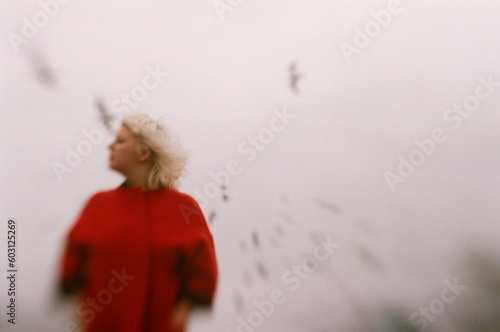 Blur portrait of a woman wearing red coat photo