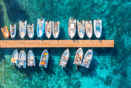 Fototapeta Aerial view of boats and luxure yachts in dock at sunset in summer in Sardinia, Italy